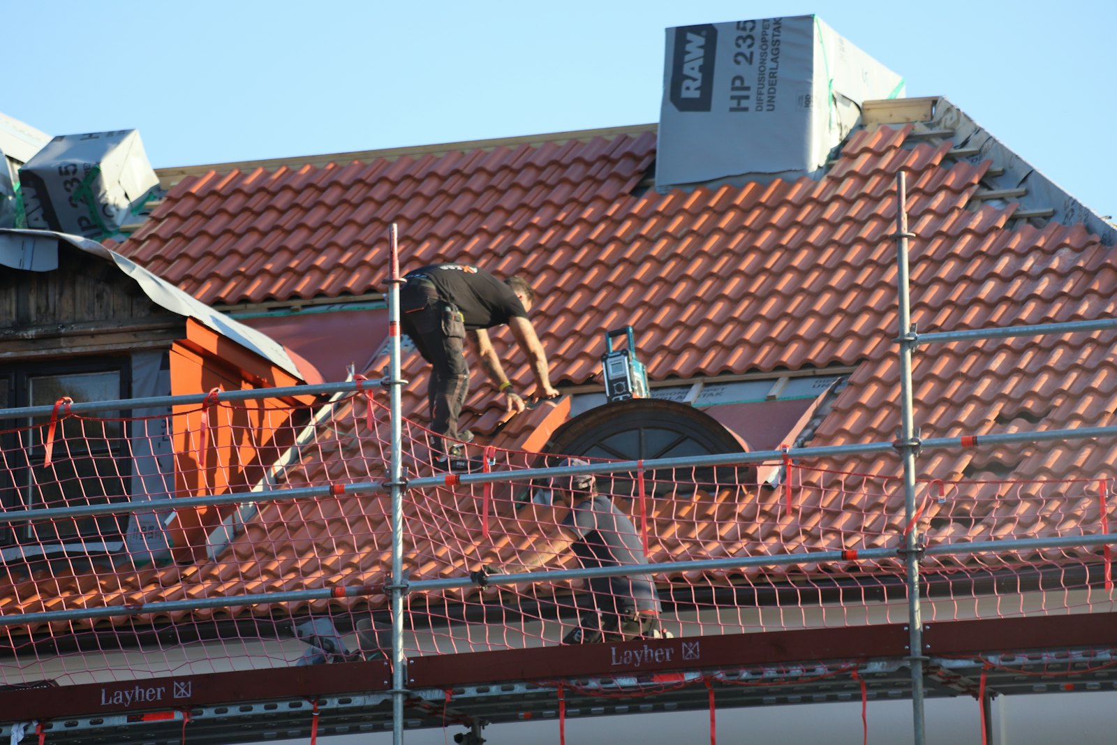 Roofer working on a tile roof